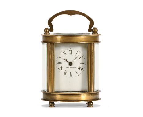 A brass French carriage clock of small form, oval in plan, timepiece only.  Height excluding carry handle 8 cm.