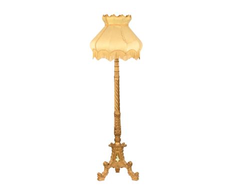 A 19th century gilt painted lamp standard, with three scroll supports together with an ornate fringed shade (see illustration