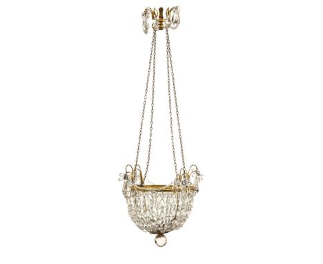 An Edwardian brass and glass crystal drop dome shaped chandelier.  90 cm high.