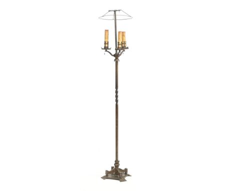 A brass lamp standard, with three light fittings and shade support, with twist column and shaped base.