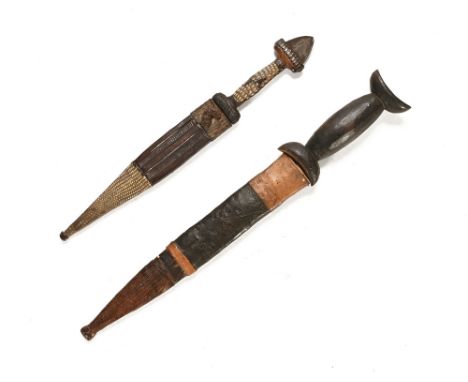 A Tuareg dagger, with a wooden handle and a 9 1/2" blade and leather sheath, collected Kano North Nigeria 1963, together with