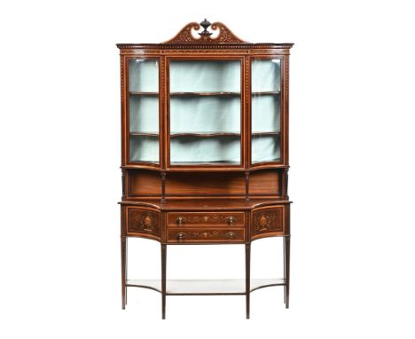 An Edwardian inlaid mahogany display cabinet, in two sections with detachable pediment above a glazed door flanked by convex 