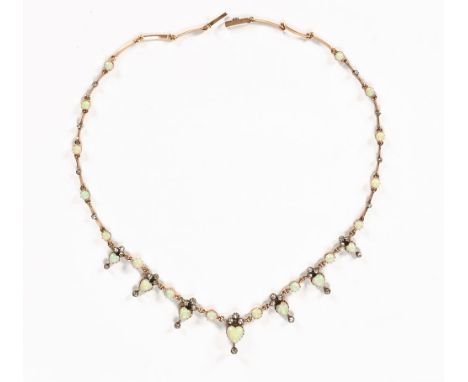 A Victorian gold coloured metal diamond and opal set necklace, with graduated heart shaped opal drops.  Length 47 cm and with