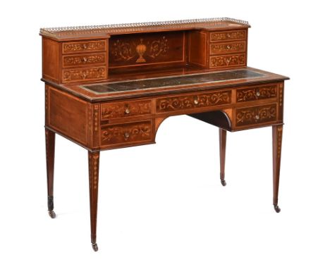 An Edwardian mahogany writing desk, with extensive foliate scroll and line inlay decoration with raised brass gallery superst