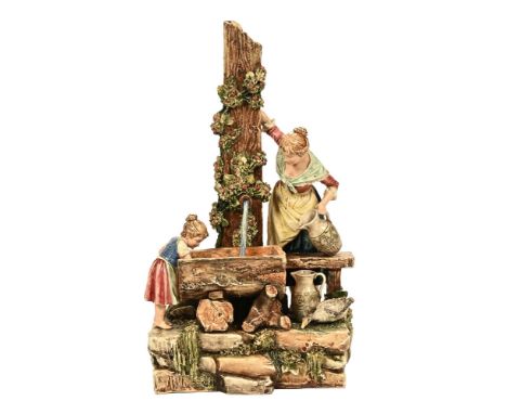A Victorian Majolica figurine depicting a mother and child at a water trough in a rural setting.  56 cm high at highest point