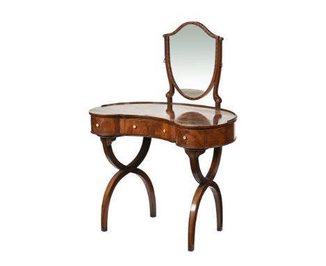 A Regency style mahogany kidney shaped dressing table, with shield shaped mirror fitted with frieze drawers and raised on Kli