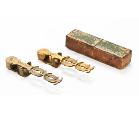 A brass sovereign and half sovereign scale, stamped Midgley & Co with crown, 9.5 cm long, together with a second brass sovere