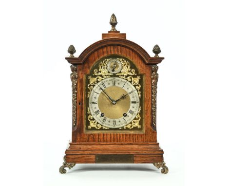A late Victorian oak frame mantel clock, with ormolu style acorn finials and applique containing silvered and brass spandrel 