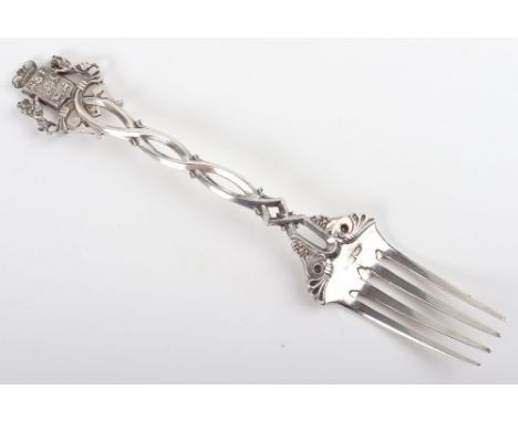 A large Russian, serving fork, Ivan Vonifatiyevich Yevstigneyev, St Petersberg 1875, interlaced handle with coat of arm finia