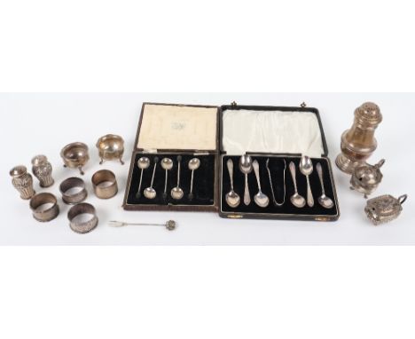 A mix of silver items, including a sugar castor, pair of pepperettes, four napkin rings, two lidded mustard pots, and two sal