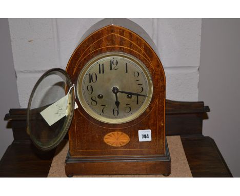An Edwardian inlaid mahogany mantel clock with silvered dial.