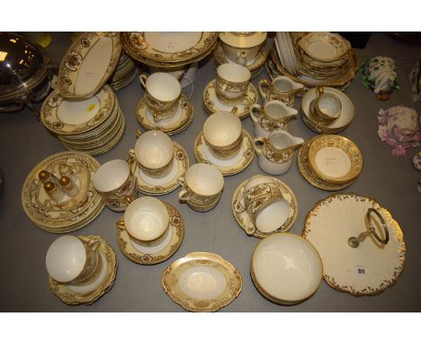 Noritake part dinner and tea service, decorated in gold and cream on white ground.