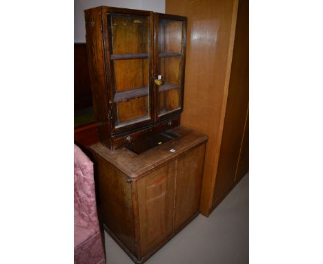 A stained oak glazed display cabinet with underlying drawer together with; a mahogany cabinet.