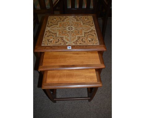 A nest of three G-plan teak and tile top coffee tables.