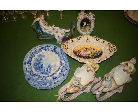 A pair of blue and white pearl ware transfer decorated plates entitled "Rural Scenary", continental ware ornaments modelled a