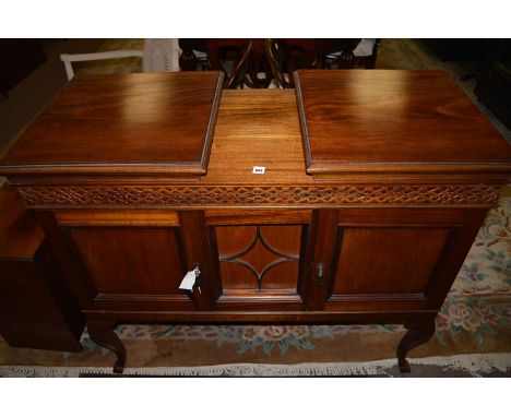 An early 20th Century mahogany double sized gramophone cabinet, the right-hand side top fitted turntable above blind fret dec