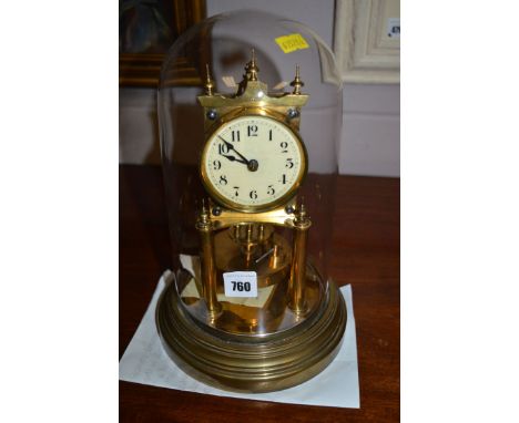 A perpetual motion clock, with white enamel arabic dial within brass movement under glass dome.