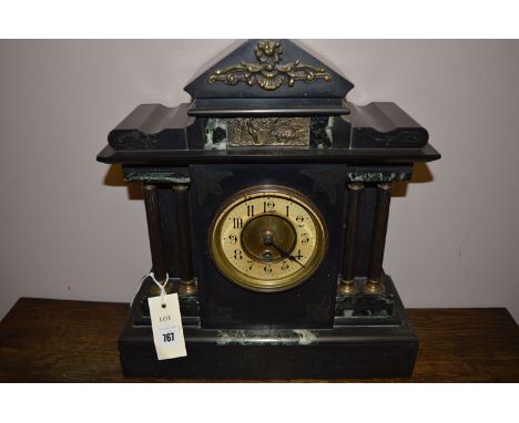A Victorian marble and slate mantel clock with column decoration.