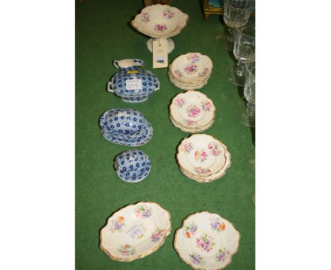 Blue and white ceramic dolls house part dinner service; and another dolls dessert service, decorated sprays of flowers and gi