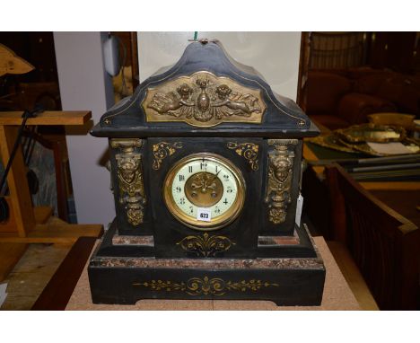 A Victorian slate and marble mantel clock, with giltmetal embellishments.
