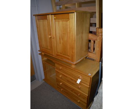 A pine cabinet, with two bevelled panel doors; together with a desk fitted four drawers.