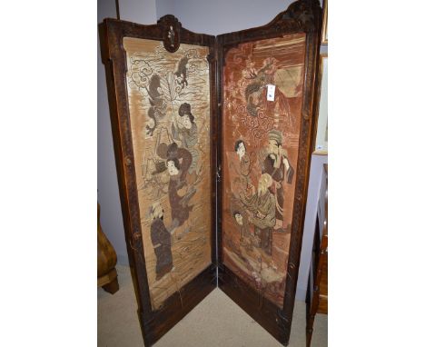 A two-fold carved stained wood Japanese shibayama inlaid screen, inset silk needlework figures and dragons, the frames with s