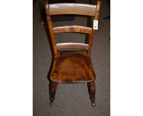 A child's 19th Centruy Windsor rocking chair, with arched ladder-back and solid elm seat raised  on turned legs joined by str