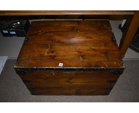 A stained pine and black painted metal bound trunk, 79cms wide.