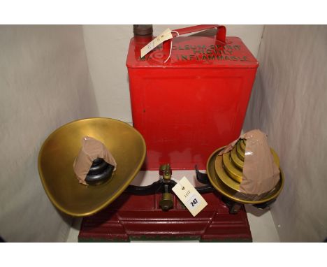 A cast iron balance with brass pans and weights; a restored petroleum can embossed inscription "SM and BP Ltd".
