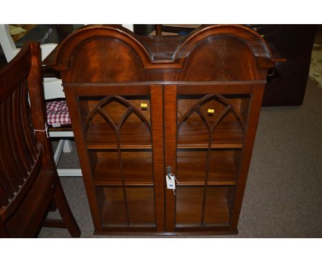 A reproduction mahogany display cabinet top, the double arched cornice above glazed panelled doors enclosing shelves, 106cms 