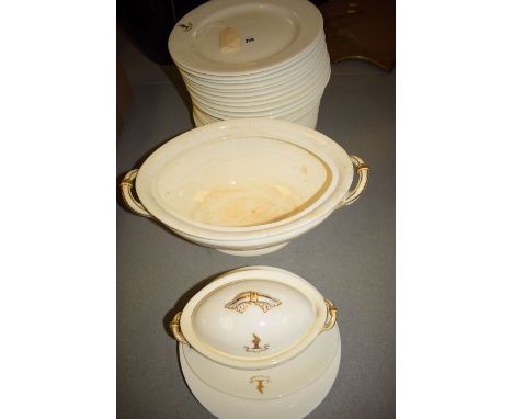 An early 20th Century white ceramic part-dinner service with gold crest, depicting a bird sitting on a sheaf of corn inscribe