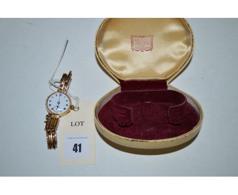 A 15ct yellow gold cased cocktail watch, white enamel roman dial with subsidiary seconds aperture, on flexible gate-link stra