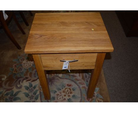 A light stained wood occasional table, fitted a single frieze drawer, raised on square legs, 48cms wide.