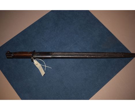 An early 20th Century bayonet, by Wilkinson, dated 1907, stained wooden hilt and leather scabbard, with metal mounts.