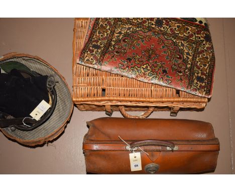 A signed Persian mat; a Fortnam & Masons wicker picnic basket; a leather Gladstone bag, with initials J.F.B to the front; a b