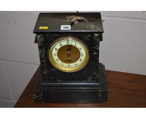 A black stone and green marble mantel clock.