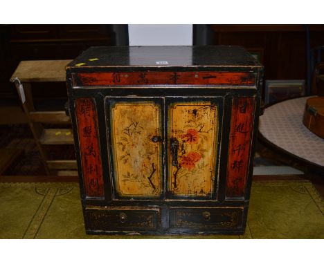 A Japanese style ebonised painted cabinet fitted a pair of panel doors above two short drawers, 45cms.