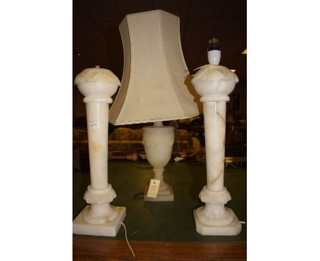 A pair of 20th Century carved alabaster table lights, tapering column raised on square plinth bases (one with canted corners)