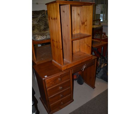 A stained pine desk fitted five drawers; a stained pine wall hanging cabinet; and a television stand.