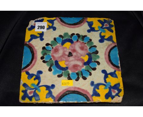 An antique Majolica tile with hand-painted polychrome decoration, probably Spanish.