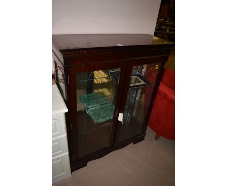 A reproduction mahogany glazed mirror back display cabinet, 89cms wide.