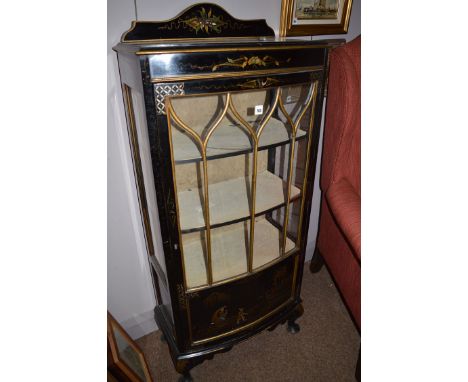 A chinoiserie display cabinet, the ebonised and gold painted case with glazed panel door and sides enclosing shelves, 62cm wi