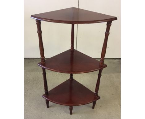 A modern mahogany coloured 3 tier corner shelf.  Approx. 76.5cm.