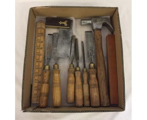 A box of vintage wood working tools. Comprising 6 chisels, all Sheffield forged. A spirit level, a box wood rule, set square 