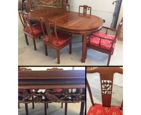 An oriental Rosewood dining table with 2 carvers and 4 chairs. Carved bird decoration to back of all chairs. Red silk embroid