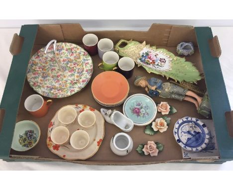 A box of misc ceramics. To include Midwinter chintz cake plate, Capodimonte ceramic flowers and Art Deco design egg cups on m