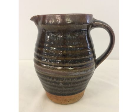 A large David Leach Lowerdown Studio pottery jug. In brown glaze with ribbed design. Lowerdown mark impressed at base of hand