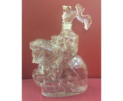 A French glass decanter in the shape of a Knight on horseback. Embossed mark 'Castagnon Nggaro France'. Measures approx 11inc
