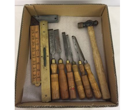 A box of vintage wood working tools. Comprising 6 Sheffield chisels, a spirit level, a set square a box rule and ball pane ha