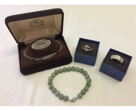 4 items of 925 silver jewellery. Comprising a jade bead bracelet, a ladies dress ring set with clear and orange stone size P 